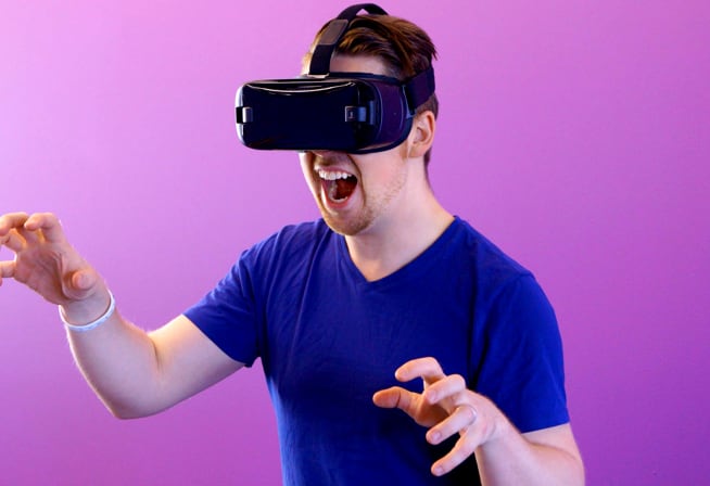 Man in a blue shirt wearing a VR headset